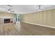 Bright living area showcasing a brick fireplace, ceiling fan, and beautiful new flooring at 2008 Falcon Glen Ct, Alpharetta, GA 30022