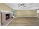 Living room with a fan, brick fireplace and wood-look flooring at 2008 Falcon Glen Ct, Alpharetta, GA 30022