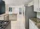 Well-lit kitchen boasts tiled floors, granite countertops and modern stainless steel appliances at 2907 Clearbrook Dr, Marietta, GA 30068