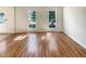 Bright living room featuring wood-look flooring, filled with natural light from dual windows at 2907 Clearbrook Dr, Marietta, GA 30068