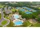 Gorgeous aerial view of community pool, tennis courts, and clubhouse surrounded by trees at 3105 Neal Ct, Cumming, GA 30041