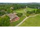 Scenic aerial view of a golf course with a clubhouse and well-manicured greens at 3105 Neal Ct, Cumming, GA 30041