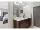 Bathroom featuring double sinks, a large mirror, and a view of the bedroom at 3105 Neal Ct, Cumming, GA 30041