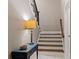 Entryway features hardwood stairs, a side table with lamp, and white accents at 3105 Neal Ct, Cumming, GA 30041