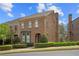 Charming brick home with manicured landscaping and beautiful architectural details under a partly cloudy blue sky at 3105 Neal Ct, Cumming, GA 30041