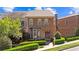 Charming townhome showcases brick facade, manicured landscaping, and a welcoming entrance at 3105 Neal Ct, Cumming, GA 30041