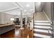 Spacious foyer featuring hardwood floors, staircase, and views of the dining and living areas at 3105 Neal Ct, Cumming, GA 30041