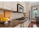 Modern kitchen with granite counters, stainless appliances, and tile backsplash at 3105 Neal Ct, Cumming, GA 30041