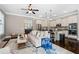 Open-concept living area with sleek white kitchen, modern appliances, and stylish island seating at 3105 Neal Ct, Cumming, GA 30041
