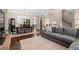 Open-concept living room and dining room featuring a stylish gray couch and decorative rug at 3105 Neal Ct, Cumming, GA 30041