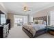 Cozy main bedroom suite with a seating area, large bed, and ample natural light at 3105 Neal Ct, Cumming, GA 30041