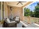 Relaxing outdoor patio featuring comfortable seating, a ceiling fan, and a serene view of lush greenery at 3105 Neal Ct, Cumming, GA 30041