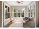 Bright sunroom filled with natural light, comfortable seating, and serene views of surrounding trees at 3105 Neal Ct, Cumming, GA 30041