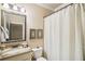 Bathroom with marble sink, white toilet, curtain, and mirror at 320 Town Center Ave # U206B, Suwanee, GA 30024