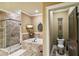 Luxurious bathroom with a soaking tub, glass enclosed shower, and neutral stone tile at 320 Town Center Ave # U206B, Suwanee, GA 30024