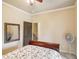 A simple bedroom with a red and white floral bedspread with an open door at 320 Town Center Ave # U206B, Suwanee, GA 30024
