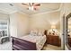 Cozy bedroom featuring a decorative bedspread, natural light, and neutral wall paint at 320 Town Center Ave # U206B, Suwanee, GA 30024