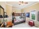 Bunk beds in the neutral bedroom with a window view and a red ottoman at 320 Town Center Ave # U206B, Suwanee, GA 30024