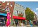Commercial building facade featuring retail and restaurant spaces, plus upper residential balconies at 320 Town Center Ave # U206B, Suwanee, GA 30024