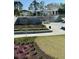 Outdoor community center featuring pergola-covered seating areas, a modern architectural design, and landscaping at 320 Town Center Ave # U206B, Suwanee, GA 30024