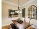 Traditional dining room with wood floors, decorative mirror and dark wood table at 320 Town Center Ave # U206B, Suwanee, GA 30024