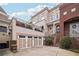 Multi-level home featuring a two car garage and upper deck at 320 Town Center Ave # U206B, Suwanee, GA 30024