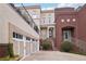 Multi-level house featuring a brick entry and an attached two-car garage at 320 Town Center Ave # U206B, Suwanee, GA 30024