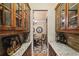 Butler's pantry with display cabinets and granite countertops leading to the dining room at 320 Town Center Ave # U206B, Suwanee, GA 30024