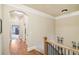 Bright upstairs hallway with hardwood floors and decorative wrought iron artwork at 320 Town Center Ave # U206B, Suwanee, GA 30024