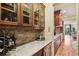 Hallway with wine and beverage coolers that connect to the kitchen and dining room at 320 Town Center Ave # U206B, Suwanee, GA 30024