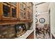 Hallway between kitchen and dining room with glass cabinets and marble counter space at 320 Town Center Ave # U206B, Suwanee, GA 30024
