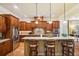 Spacious kitchen features a large island, granite countertops, stainless steel appliances, and wooden cabinetry at 320 Town Center Ave # U206B, Suwanee, GA 30024