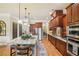 Modern kitchen boasting granite countertops, stainless steel appliances, custom wood cabinets, and an eat-in island at 320 Town Center Ave # U206B, Suwanee, GA 30024