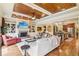 Open-concept living room with a fireplace, a wood tray ceiling, and hardwood floors at 320 Town Center Ave # U206B, Suwanee, GA 30024