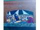 Brick building featuring a large, colorful mural depicting a music scene with musicians and a crowd at 320 Town Center Ave # U206B, Suwanee, GA 30024