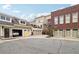 Rear exterior of the home with multiple garages and an outdoor patio at 320 Town Center Ave # U206B, Suwanee, GA 30024