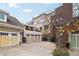 Back of home with a variety of garages and an outdoor patio at 320 Town Center Ave # U206B, Suwanee, GA 30024
