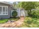 Landscaped backyard featuring a walkway, white fence, and mature greenery at 3860 Carlton Dr, Atlanta, GA 30341