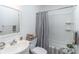 Bathroom with a single sink vanity, tub and shower, and a mirror at 3860 Carlton Dr, Atlanta, GA 30341