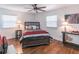 Cozy bedroom featuring hardwood floors, a ceiling fan, and natural light from two windows at 3860 Carlton Dr, Atlanta, GA 30341