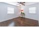 Minimalist bedroom with hardwood floors, a ceiling fan, and natural light from two windows at 3860 Carlton Dr, Atlanta, GA 30341