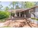 Attached carport of a gray brick home with brick floor at 3860 Carlton Dr, Atlanta, GA 30341