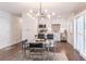 Dining area boasts modern chandelier, table with seating, and seamless flow to the kitchen at 3860 Carlton Dr, Atlanta, GA 30341
