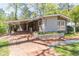 Charming gray brick home with brick walkway, flowerbed, and attached carport at 3860 Carlton Dr, Atlanta, GA 30341