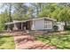 Charming gray brick home with brick walkway, manicured lawn, and carport at 3860 Carlton Dr, Atlanta, GA 30341