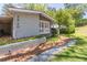 Gray brick home with brick walkway, flowerbed, and manicured front yard at 3860 Carlton Dr, Atlanta, GA 30341