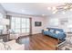 Bright living room featuring hardwood floors, modern lighting, and large windows with plantation shutters at 3860 Carlton Dr, Atlanta, GA 30341
