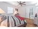 Bedroom featuring a modern bed, ensuite bathroom, hardwood floors, and a ceiling fan at 3860 Carlton Dr, Atlanta, GA 30341