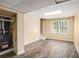 Finished basement area with wood-look floors, a window view, and an access door at 1855 Mountain Trce, Canton, GA 30114