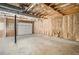 Spacious basement features unfinished walls, concrete floor, and garage door for potential customization at 1855 Mountain Trce, Canton, GA 30114